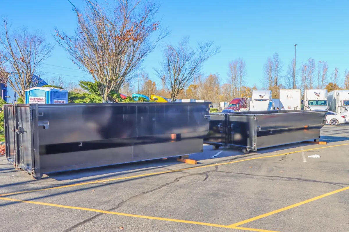 Professional dumpster rental service with roll-off container on residential driveway in Edgemoor